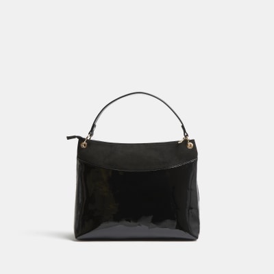 Black patent RI monogram embossed slouch bag River Island