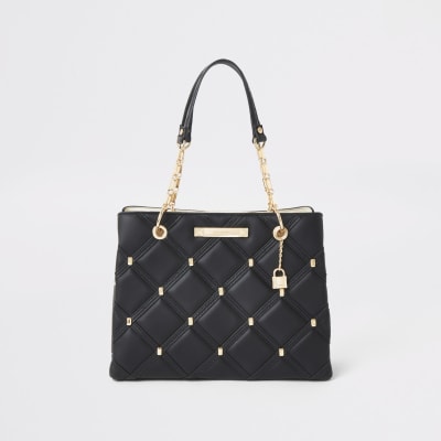 black and gold river island bag