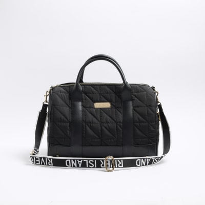 Black quilted travel bag River Island
