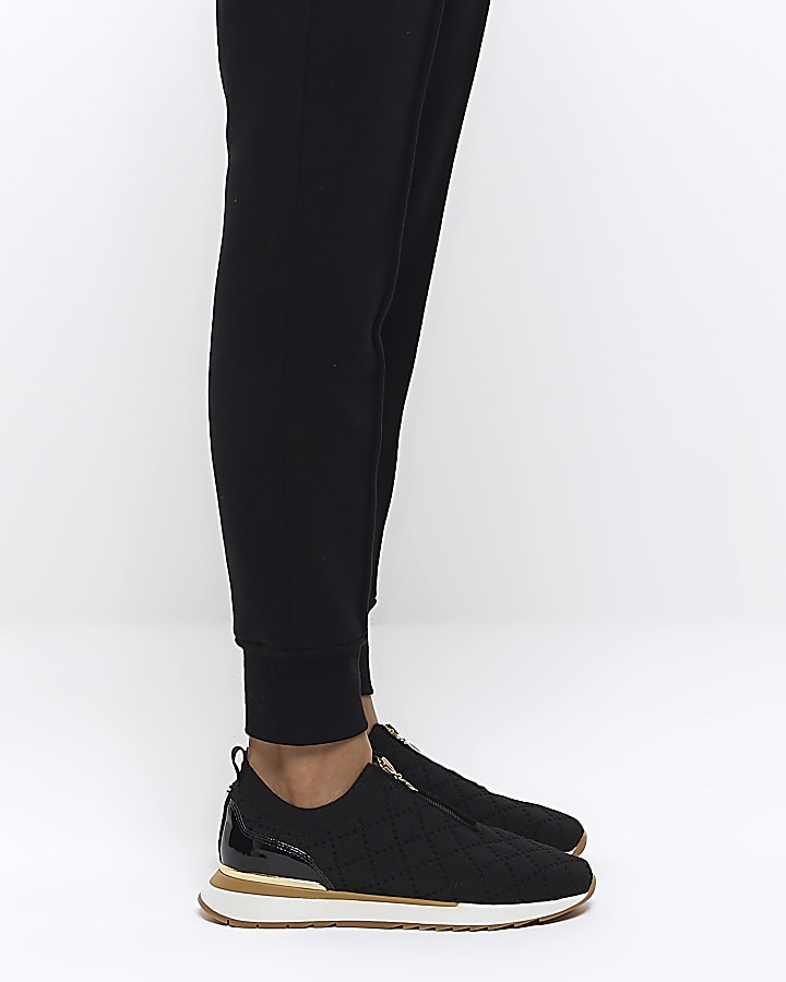 Black quilted zip trainers
