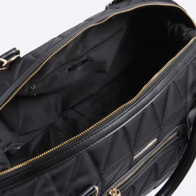 Black quilted zip travel bag River Island