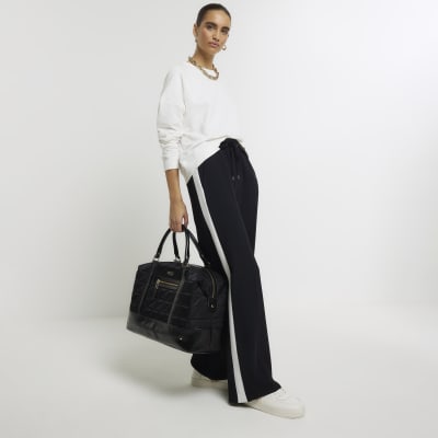Black quilted zip travel bag River Island