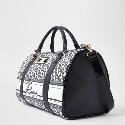 Black RI monogram barrel bag | River Island