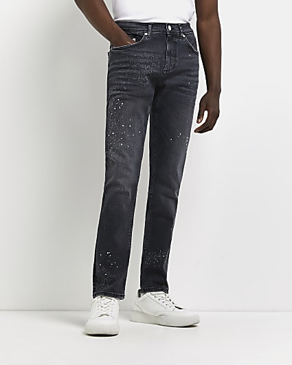 Black skinny relaxed fit paint splat jeans