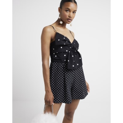 Black spot bow sleeveless playsuit River Island