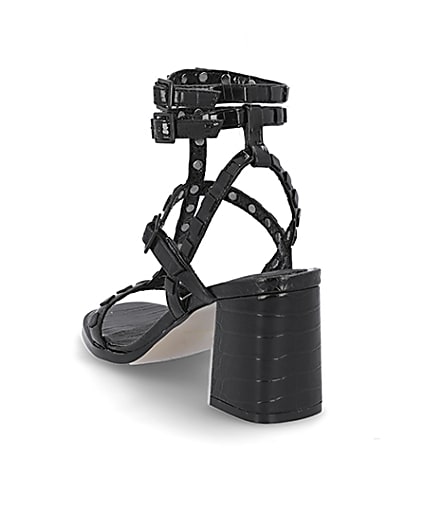 360 degree animation of product Black studded gladiator block heel sandals frame-7
