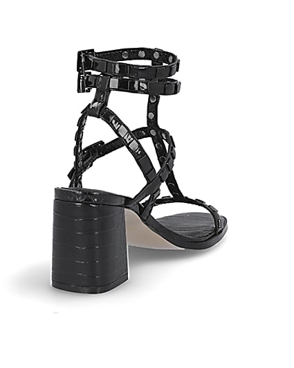 360 degree animation of product Black studded gladiator block heel sandals frame-11