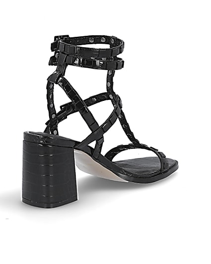360 degree animation of product Black studded gladiator block heel sandals frame-12