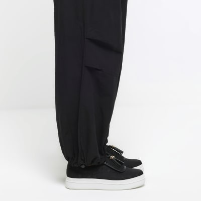 Black tassel faux leather trainers