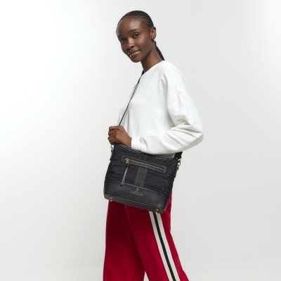 Black webbing quilted cross body bag River Island