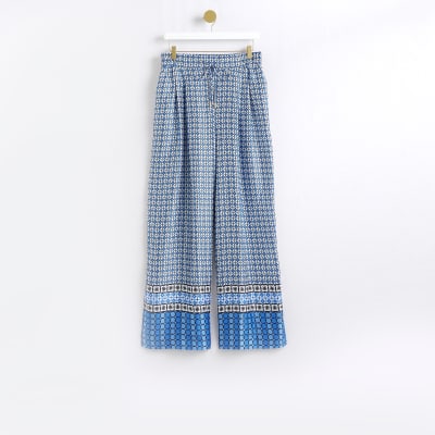 Blue geometric print wide leg trousers | River Island