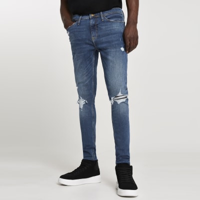 Blue ripped Ollie superskinny spray on jeans | River Island