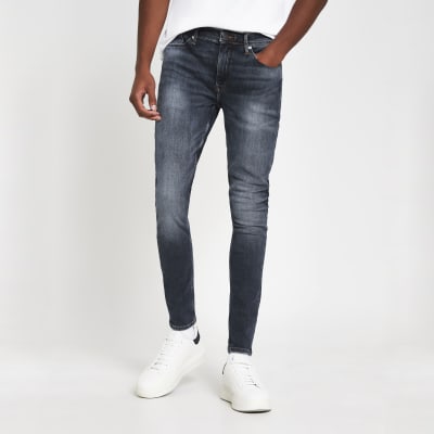 Blue spray on skinny denim jeans | River Island