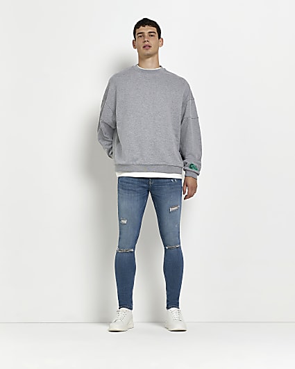 Blue spray on skinny fit ripped jeans
