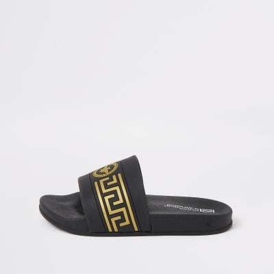 Boys black wasp crest embossed sliders 