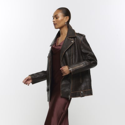 River Island brown distressed look faux leather oversized biker jacket. Oversized fit, Faux leather, Distressed look, Zip pockets, Zip fastening. 