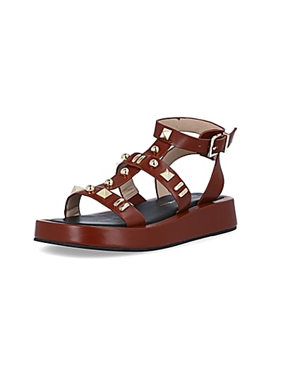 360 degree animation of product Brown studded gladiator sandals frame-0