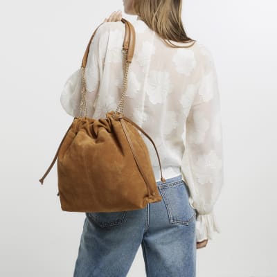 Brown suede drawstring shoulder bag River Island