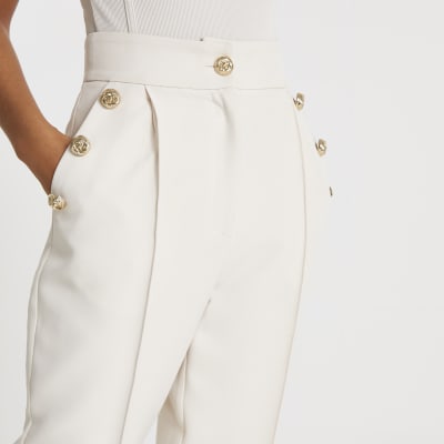 Cream button front peg trousers