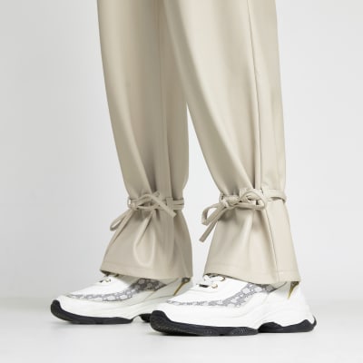 Cream faux leather tie bottom trousers