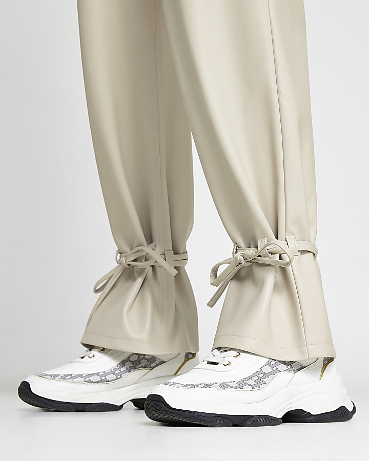 Cream faux leather tie bottom trousers