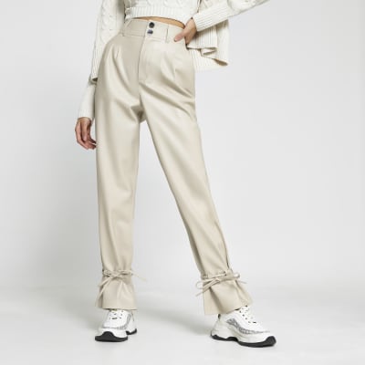 Cream faux leather tie bottom trousers