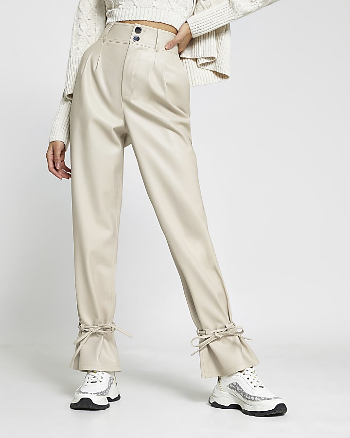 Cream faux leather tie bottom trousers
