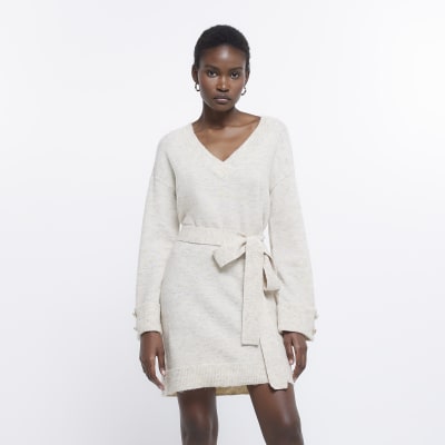 https://images.riverisland.com/is/image/RiverIsland/cream-knit-belted-jumper-mini-dress_758068_main?$ProductListingPortrait$