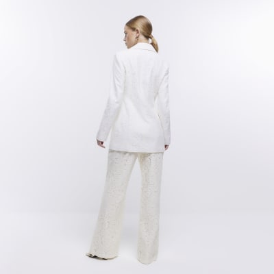 Cream lace flared trousers River Island