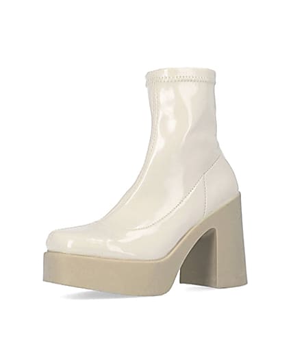 360 degree animation of product Cream patent heeled ankle boots frame-1