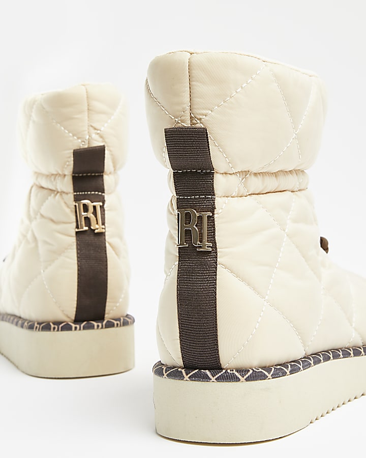 Cream RI monogram quilted puffer snow boots