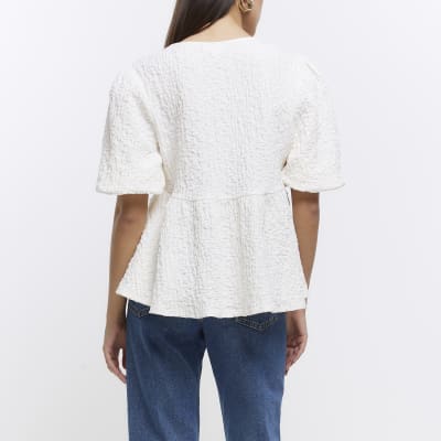Cream textured peplum short sleeve top