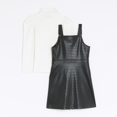 Girls black faux leather pinafore dress River Island