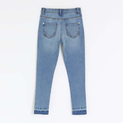 Girls denim let down hem skinny jeans | River Island