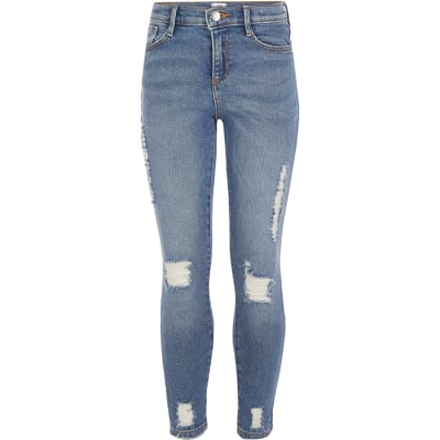 Girls mid blue ripped slim Amelie jeans | River Island