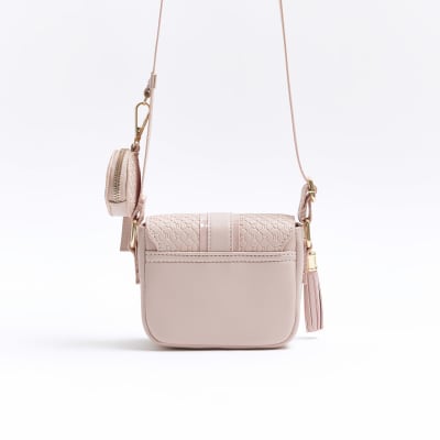 Girls pink embossed RI cross body bag River Island
