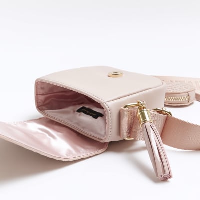 Girls pink embossed RI cross body bag River Island