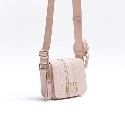 Girls pink embossed RI cross body bag River Island