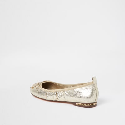 Gold bow ballerina shoes