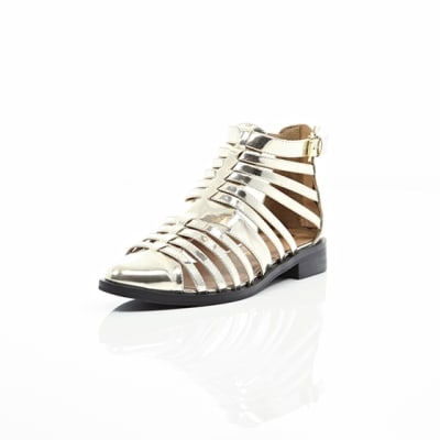 360 degree animation of product Gold closed toe gladiator sandals frame-1