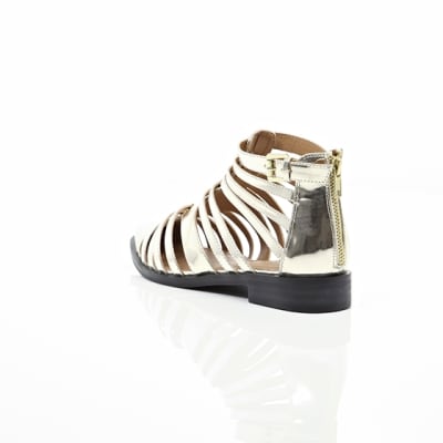360 degree animation of product Gold closed toe gladiator sandals frame-18