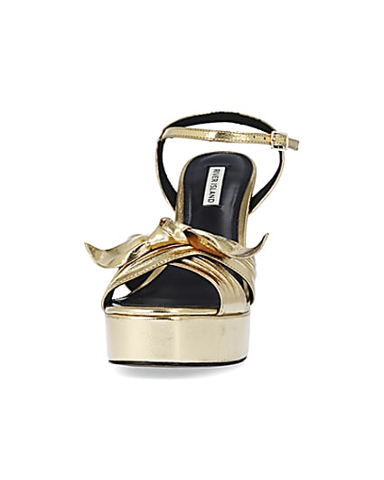 360 degree animation of product Gold knot platform heeled sandals frame-22
