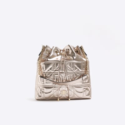 Gold quilted drawstring shoulder bag River Island