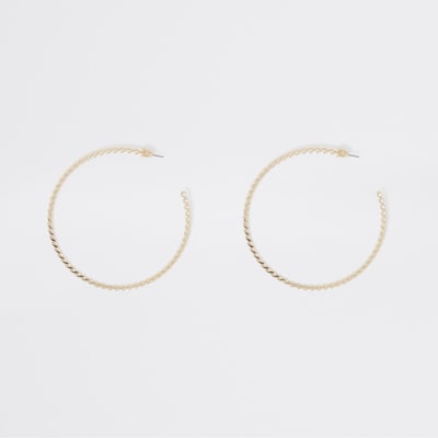 Gold tone large twisted hoop earrings