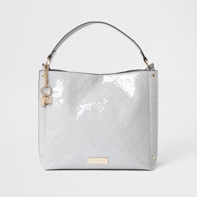 Grey patent embossed slouch bag | River Island