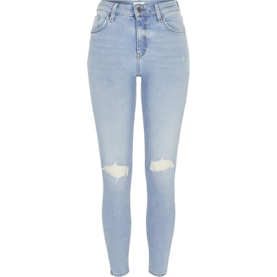 light blue ripped knee jeans