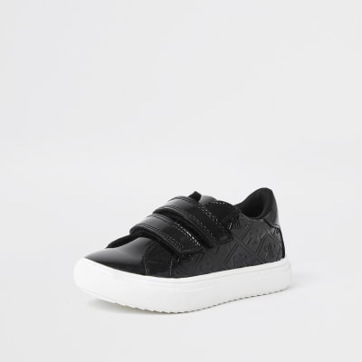girls black patent trainers