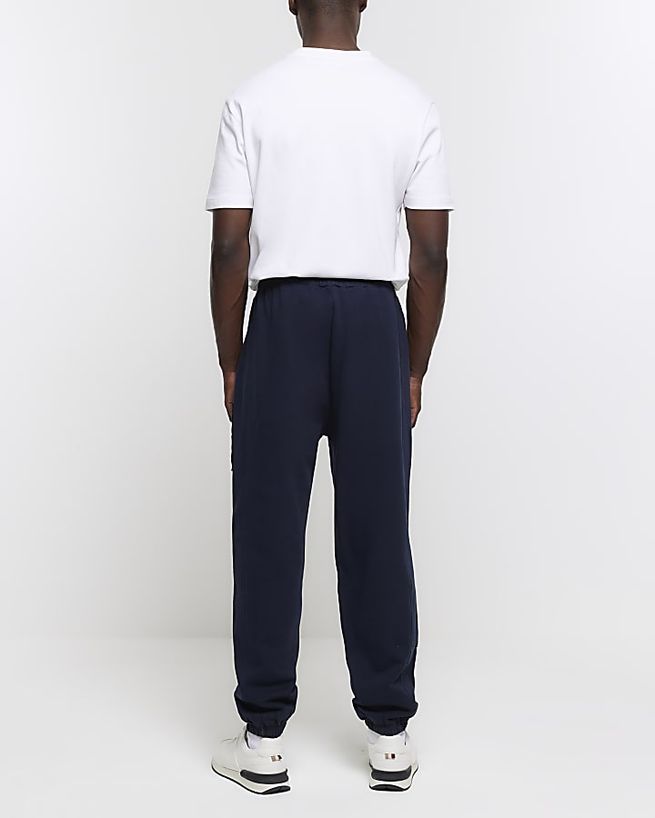 Navy regular fit gothic graphic sweatpants | River Island