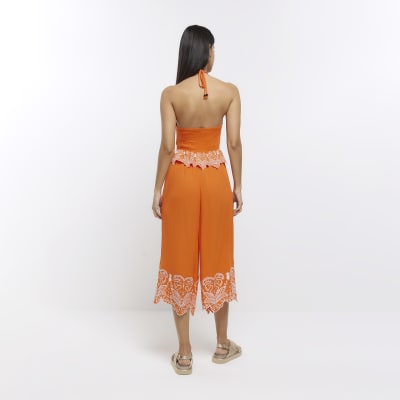 Orange halter neck cut out jumpsuit River Island