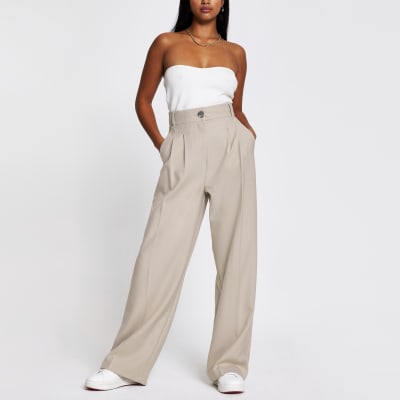 Petite beige wide leg pleat front trousers | River Island